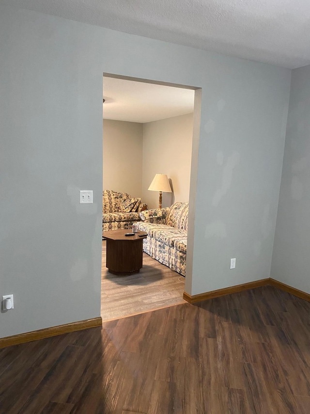 interior space with a textured ceiling and hardwood / wood-style flooring