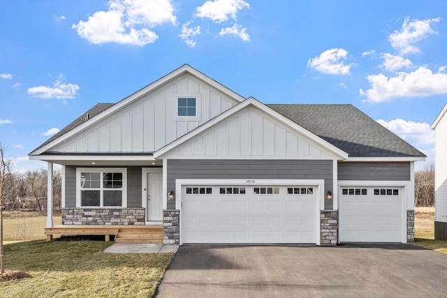 craftsman inspired home featuring a front yard, a porch, and a garage