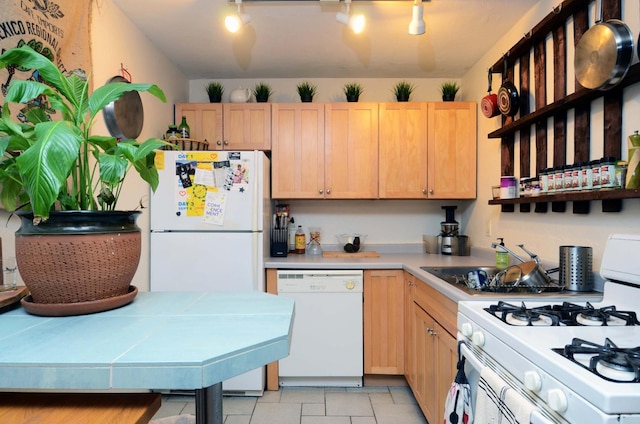 kitchen featuring light tile patterned flooring, white appliances, and light brown cabinetry