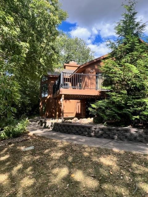 back of property with a wooden deck