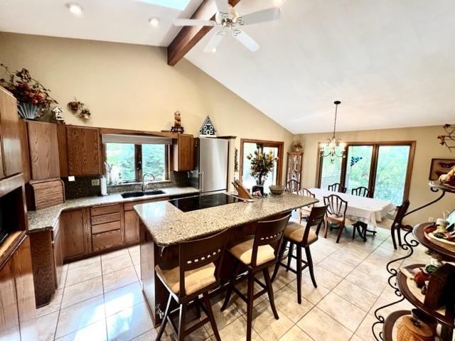 kitchen with a center island, plenty of natural light, decorative light fixtures, and a breakfast bar area