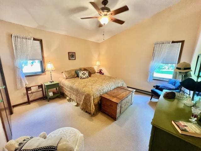 carpeted bedroom with ceiling fan and baseboard heating