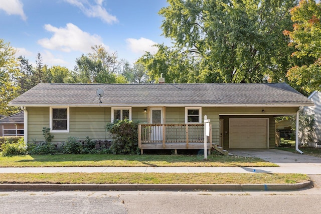 single story home featuring a front lawn and a garage