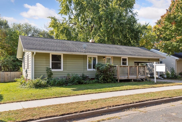 single story home with a front yard and a wooden deck