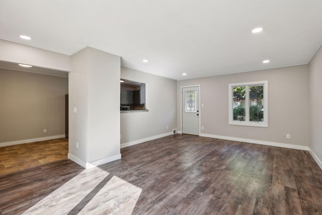 unfurnished living room with dark hardwood / wood-style flooring