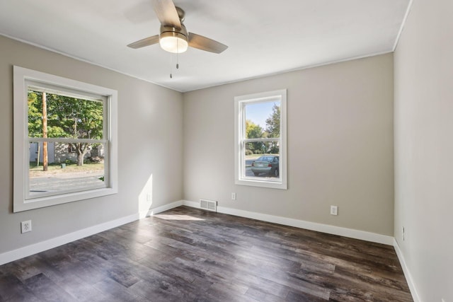 spare room with dark hardwood / wood-style floors and ceiling fan