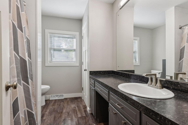 bathroom featuring vanity, toilet, and hardwood / wood-style flooring