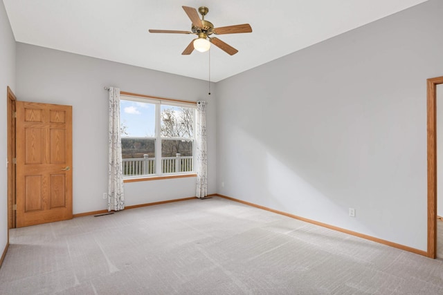 carpeted empty room featuring ceiling fan