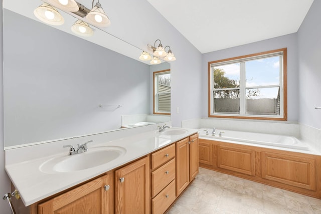 bathroom with a bath, vanity, and an inviting chandelier