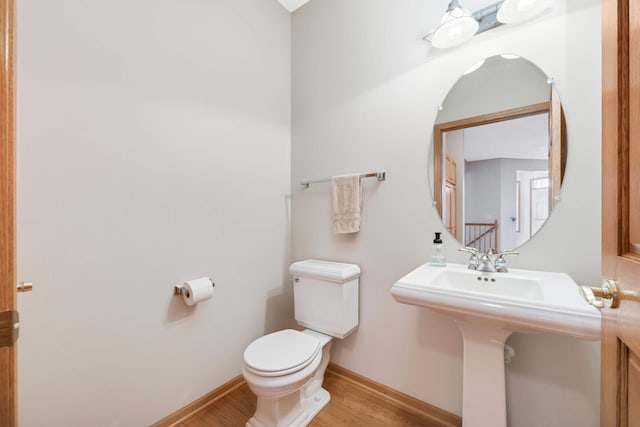 bathroom with sink, wood-type flooring, and toilet