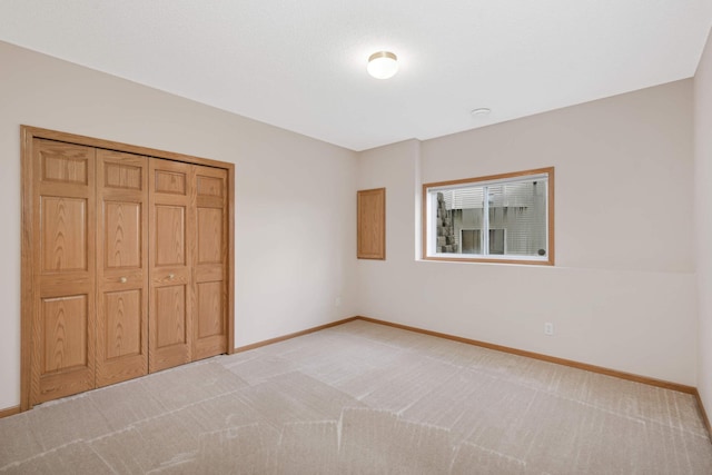 unfurnished bedroom featuring carpet and a closet