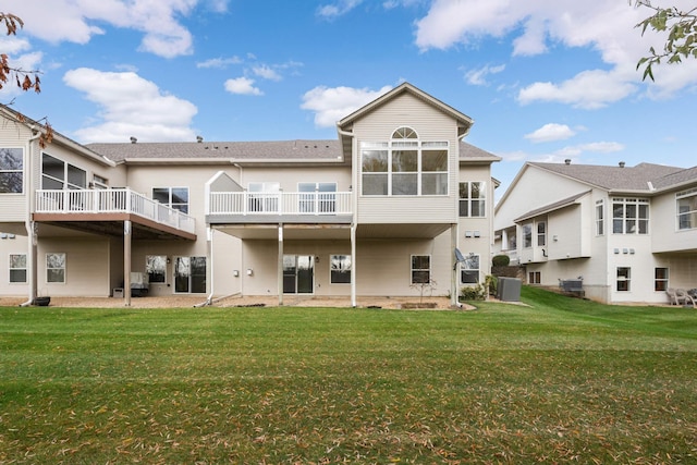 back of property featuring central air condition unit and a lawn