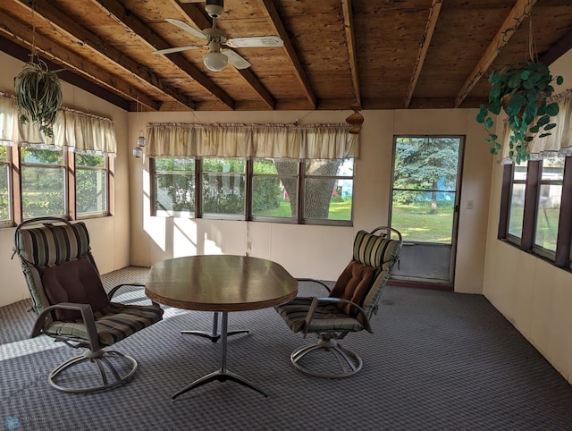 unfurnished sunroom featuring wood ceiling, lofted ceiling with beams, ceiling fan, and a wealth of natural light