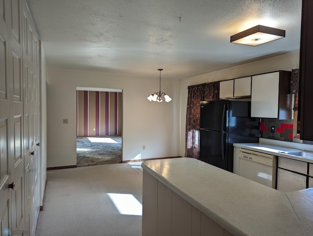 kitchen featuring pendant lighting, dishwasher, white cabinetry, light colored carpet, and an inviting chandelier