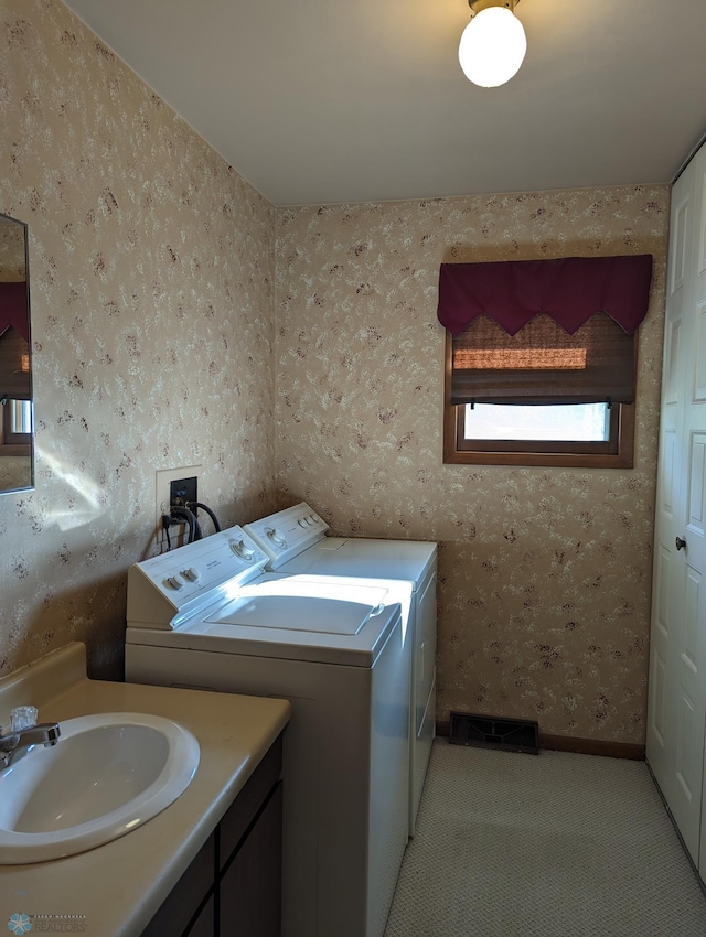 laundry area with sink and washing machine and dryer