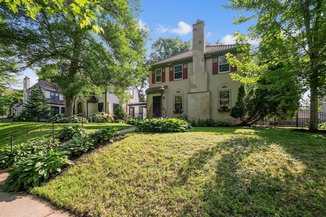4837 11th Ave S, Minneapolis, MN 55417 - mediterranean / spanish-style home with stucco siding, a tiled roof, and a chimney