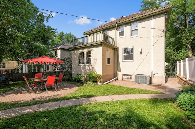 4837 11th Ave S, Minneapolis, MN 55417 - back of property featuring a balcony, a patio, stucco siding, and a tile roof