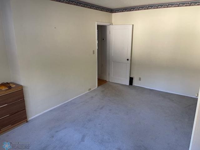 unfurnished room featuring light colored carpet