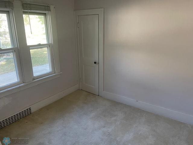 empty room with light colored carpet