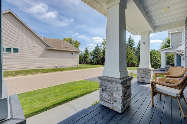 wooden deck with a yard and a porch