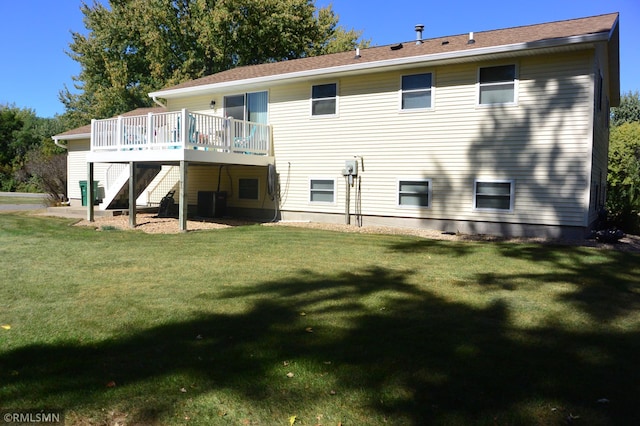 back of house with a deck and a yard