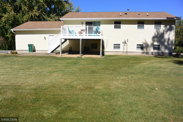 back of property featuring a deck and a yard