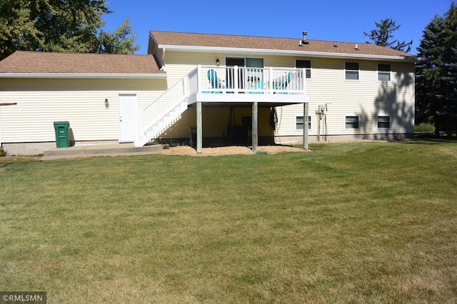 back of property with a deck and a yard