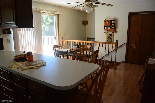 interior space featuring ceiling fan, dark wood-type flooring, and a textured ceiling