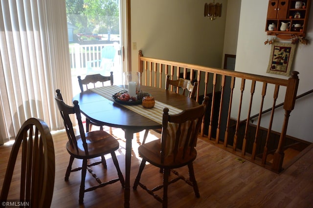 dining space with hardwood / wood-style floors