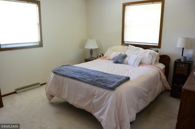 bedroom with light colored carpet and baseboard heating