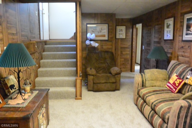 living room with carpet floors and wooden walls