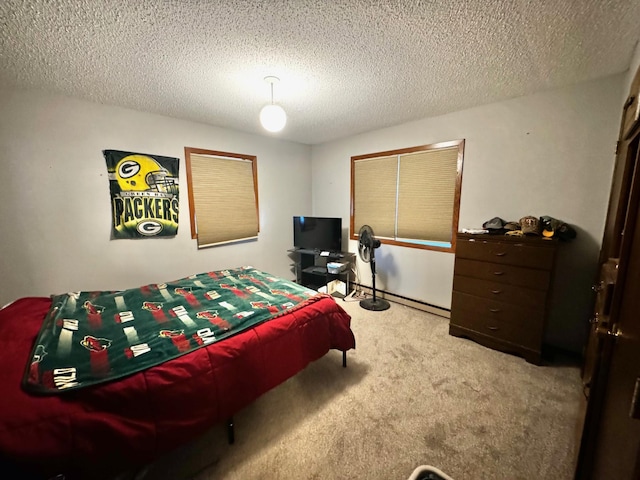 bedroom with light carpet and a textured ceiling