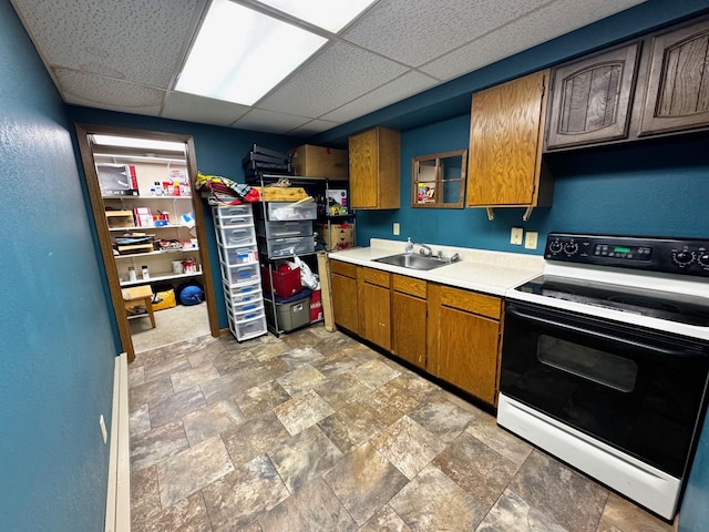 kitchen featuring a drop ceiling, white electric range, and sink