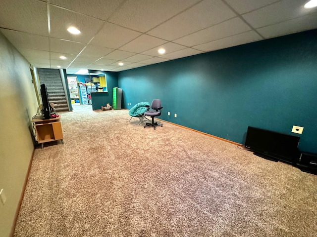 unfurnished room featuring carpet and a paneled ceiling