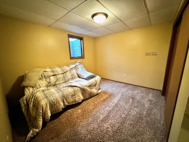 carpeted bedroom with a drop ceiling