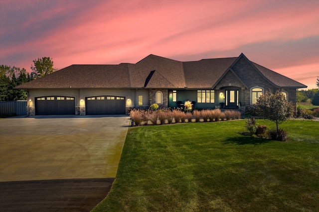 view of front of house featuring a lawn and a garage