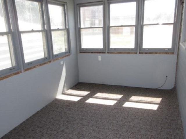 unfurnished sunroom with a wealth of natural light