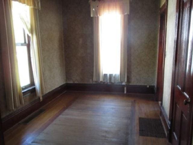 unfurnished room with hardwood / wood-style floors