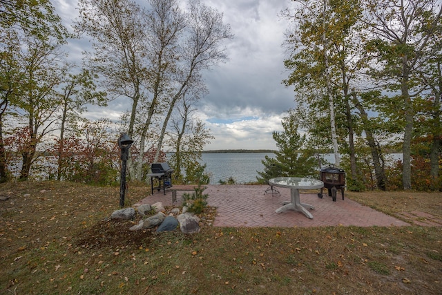 view of yard with a water view and a patio area