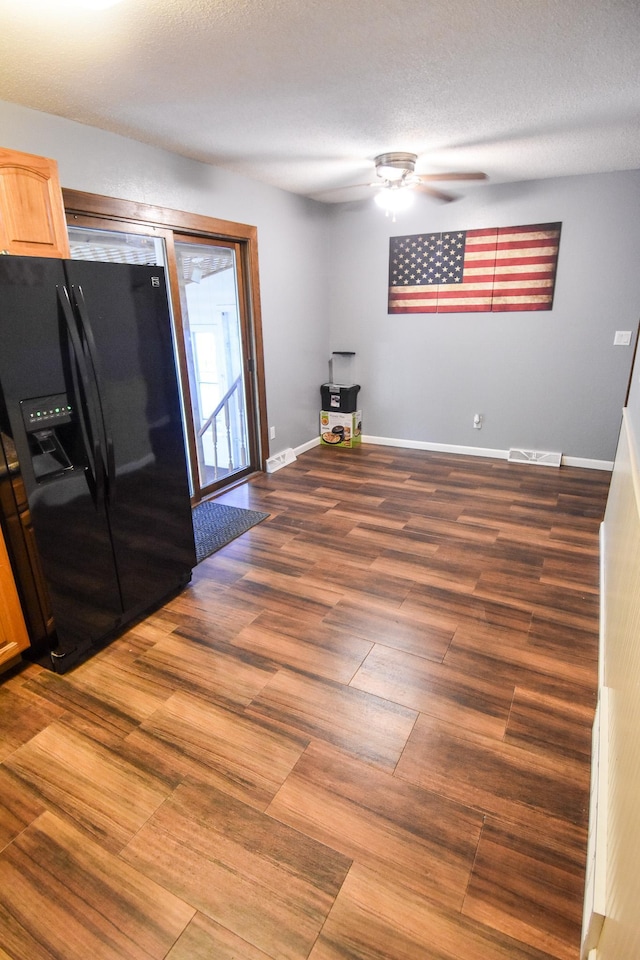 interior space featuring a textured ceiling, ceiling fan, and dark hardwood / wood-style flooring