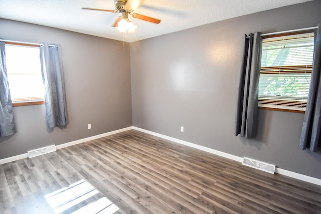 spare room featuring ceiling fan, a textured ceiling, and wood-type flooring