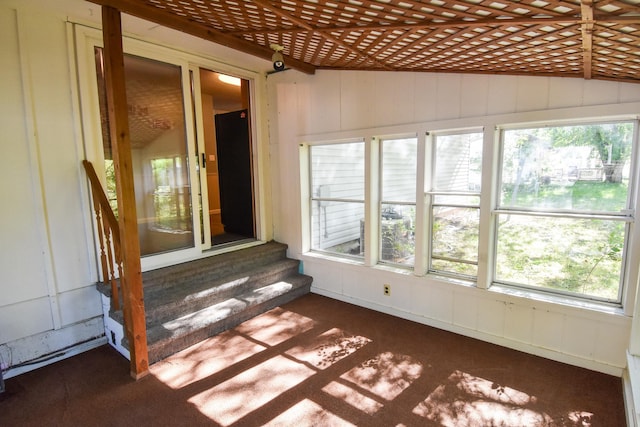 unfurnished sunroom featuring lofted ceiling