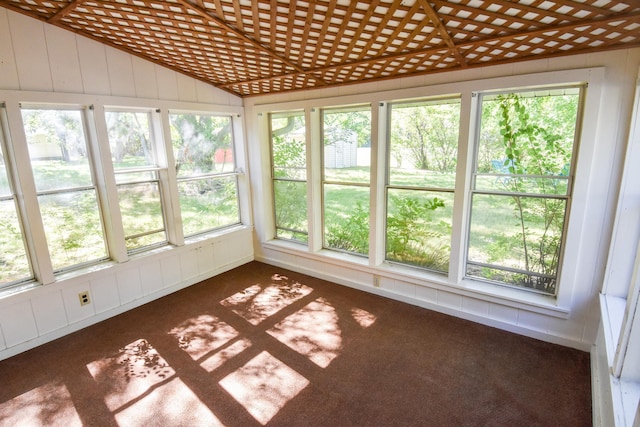 unfurnished sunroom featuring vaulted ceiling and a wealth of natural light