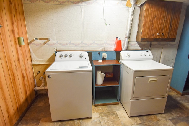 washroom with cabinets and washer and dryer