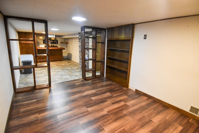 basement with dark hardwood / wood-style flooring