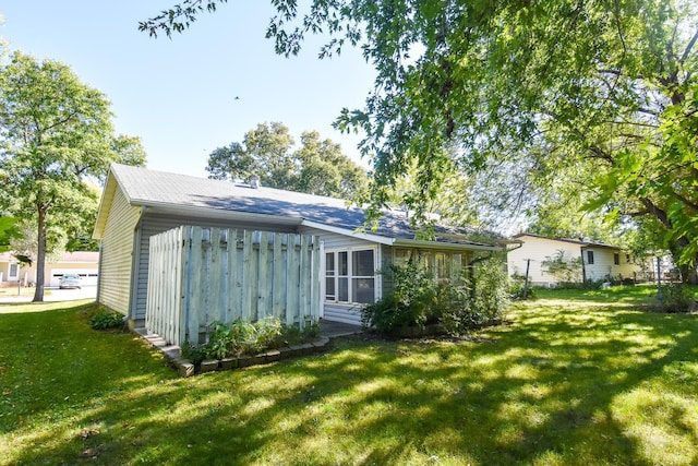 rear view of house featuring a yard