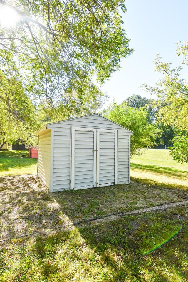 view of outbuilding with a lawn