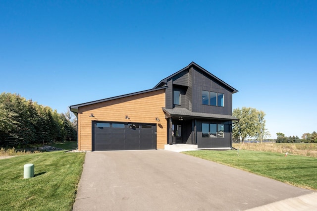 contemporary house with a garage and a front lawn