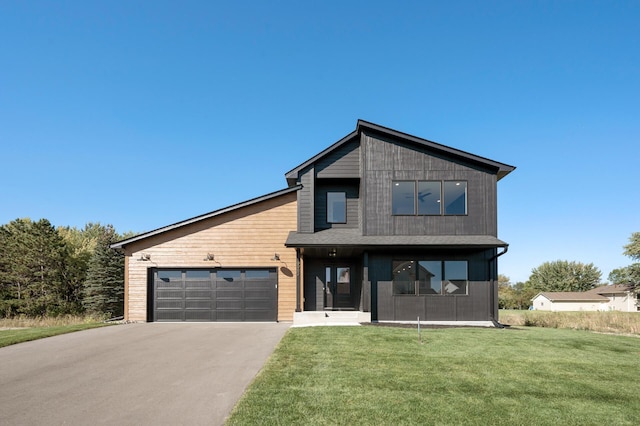 modern home featuring a garage and a front lawn