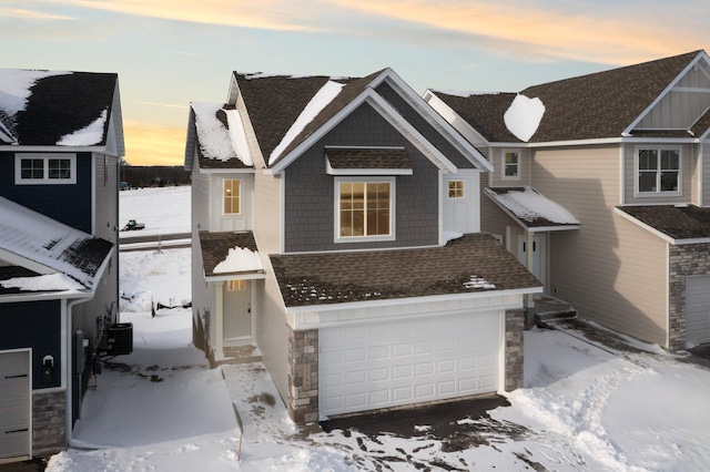 view of front of home with cooling unit and a garage